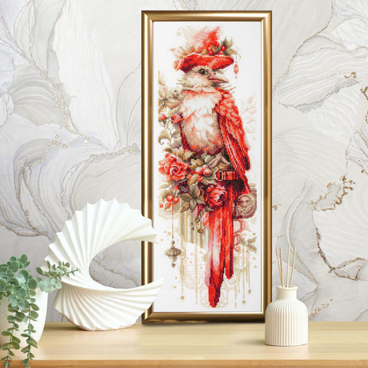 Kit de punto de cruz Magic Needle Haute Couture con diseño de ave exótica con sombrero y flores en tonos rojos, bordado elegante y artístico para decoración y colección.