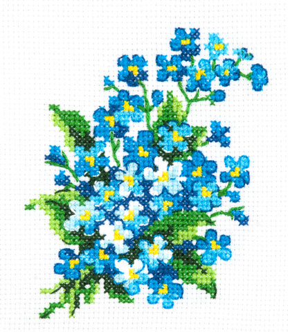 Kit de punto de cruz Nomeolvides de Magic Needle con flores azules, centros amarillos y hojas verdes sobre tela Aida blanca
