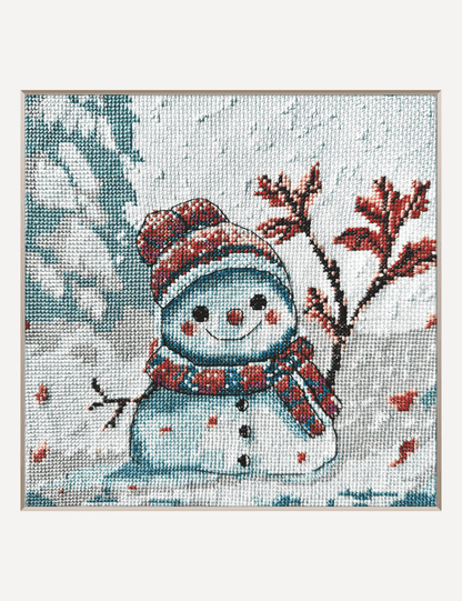 Kit de punto de cruz AINE Invierno Torpe con muñeco de nieve sonriente en paisaje invernal.