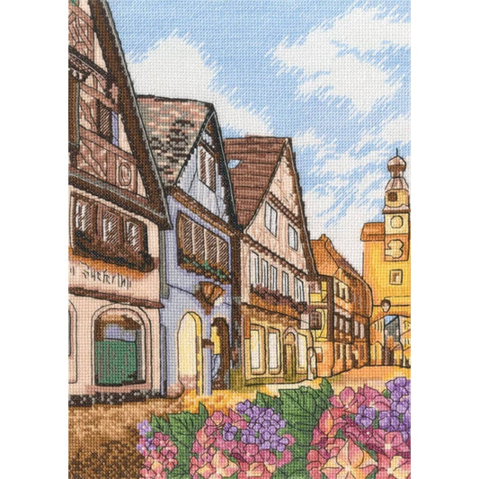 Kit de punto de cruz RTO "Calle del Casco Antiguo" con calle europea, casas tradicionales y flores. Incluye tela Zweigart, hilos DMC, aguja e instrucciones.