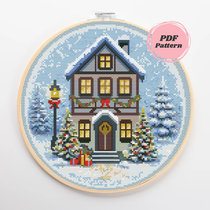 Patrón de punto de cruz de una acogedora casa nevada con decoración navideña