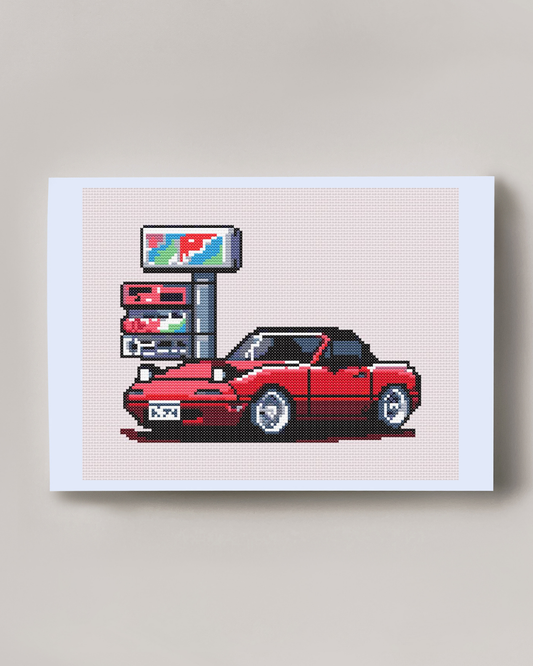 Patrón de punto de cruz de un Mazda Miata estílo JDM en una gasolinera