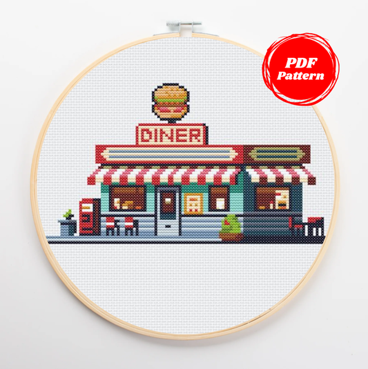 Patrón de punto de cruz de un acogedor diner americano con una hamburguesa gigante en el techo