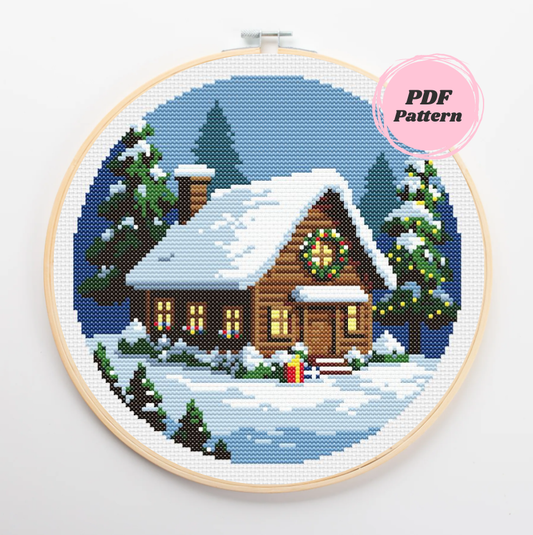 Patrón de punto de cruz de una cabaña de madera acogedora nevada en medio del bosque con decoración navideña