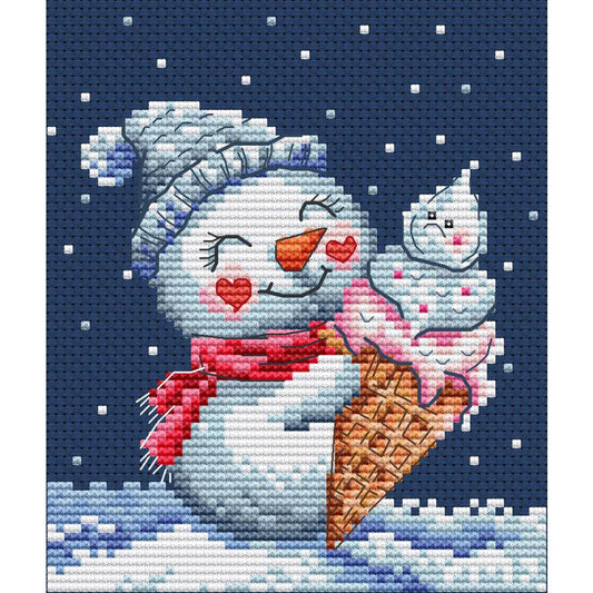 Kit de punto de cruz Collection D'Art "Muñeco de Nieve Helado" con muñeco de nieve comiendo helado en paisaje nevado. Incluye tela Aida, hilos DMC, aguja e instrucciones.