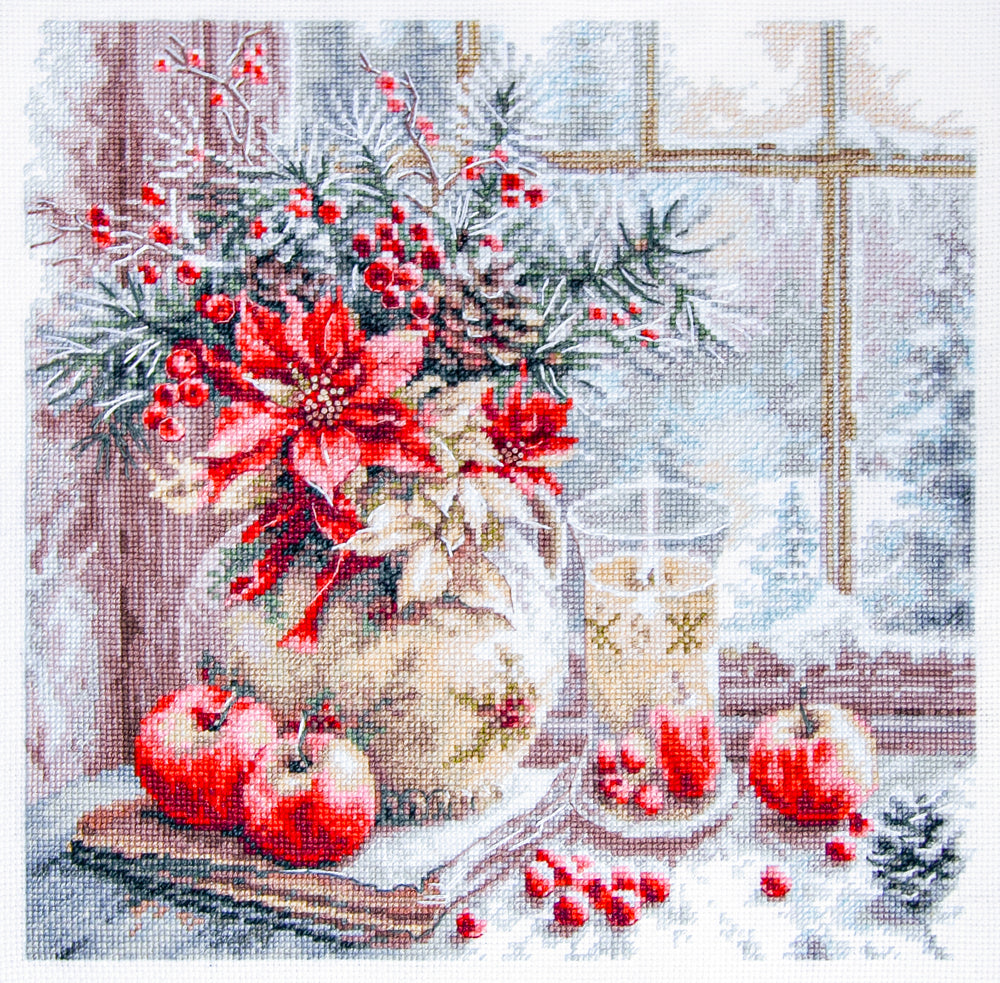Kit de Punto de Cruz Magic Needle “A Candle Was Burning” 70-50 con diseño navideño de vela, flores y manzanas sobre una mesa junto a una ventana.