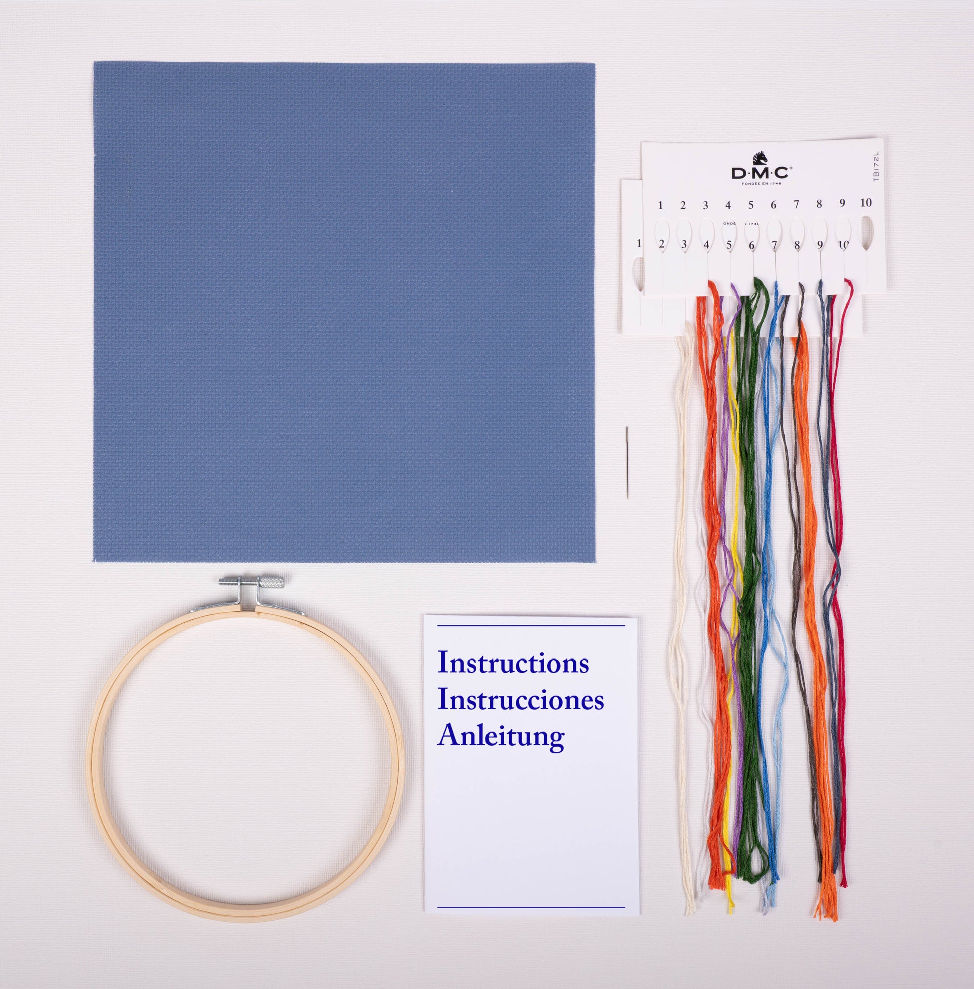 Contenido del kit de punto de cruz DMC Furgoneta Naranja con tela Aida azul, hilos Mouliné Spécial, bastidor, aguja e instrucciones