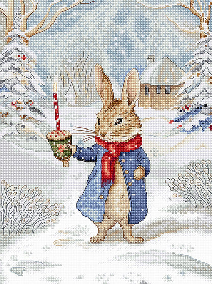 Kit de punto de cruz "Christmas Caroling" de Letistitch con diseño de un conejo cantando villancicos con una vela en un paisaje nevado y navideño.