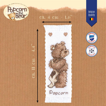 Kit punto de cruz marcapáginas Popcorn the Bear de Vervaco ambientado con libro abierto
