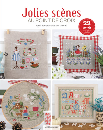 Portada del libro “Jolies scènes au point de croix” de Lilli Violette (Les Éditions de Saxe) con 22 proyectos: boutique, cojín floral, escena campestre y abecedario bordado.