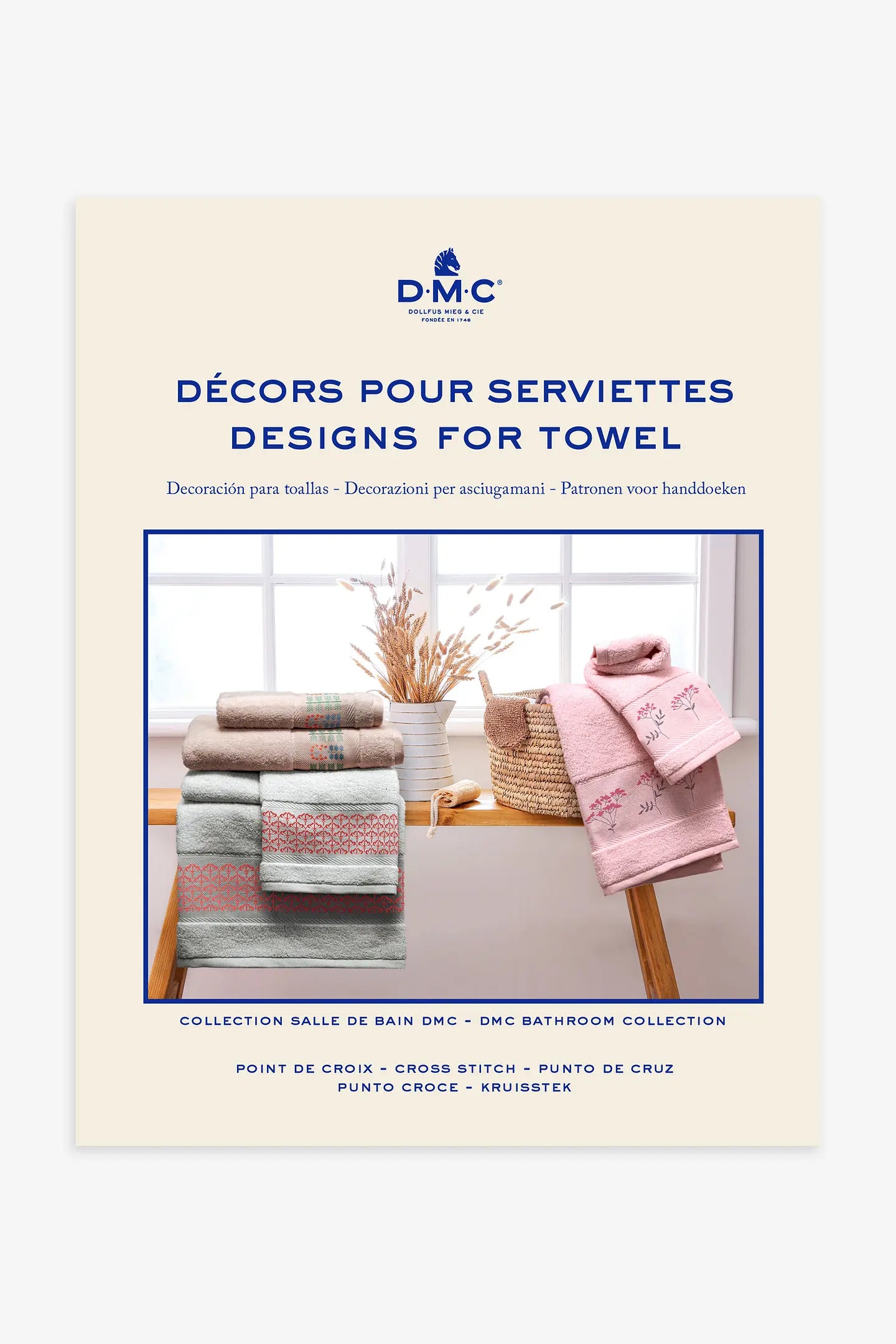 Libro de punto de cruz DMC motivos para toallas con diseños bordados en textiles de baño como flores y cenefas.