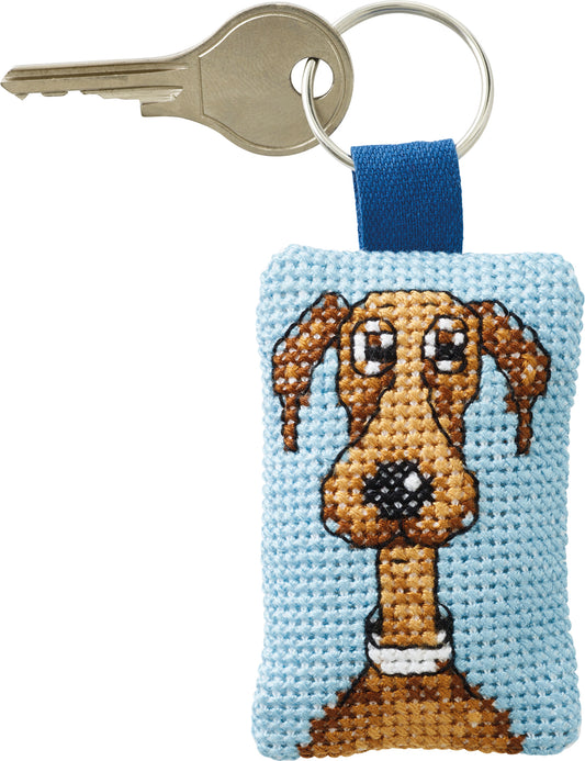 Kit de punto de cruz Permin llavero perro marrón sobre fondo azul celeste con anilla metálica, incluye tela Aida, hilos, aguja e instrucciones.