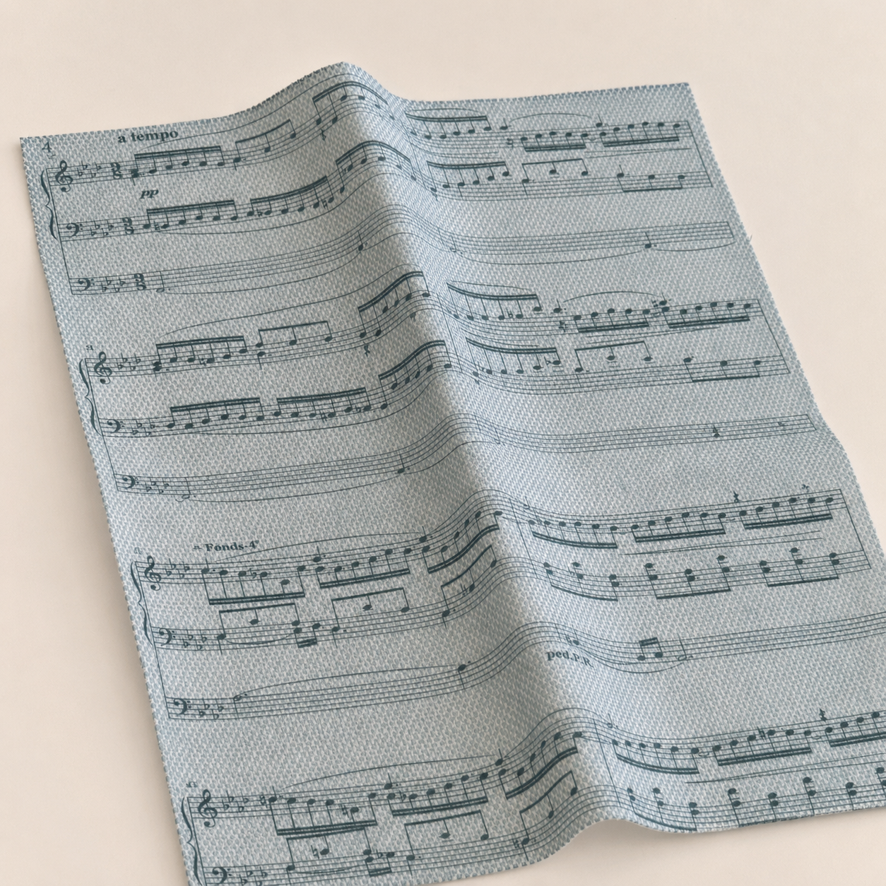 Tela Aida impresa Partitura Musical de Loisirs Créatifs vista en perspectiva con diseño de notas musicales sobre fondo azul grisáceo.