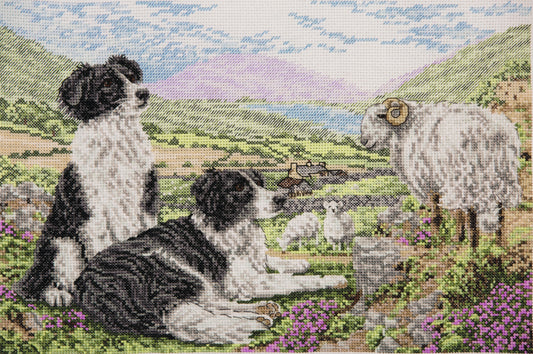 Bordado en punto de cruz de dos perros pastores con sus cabras en el prado de Anchor